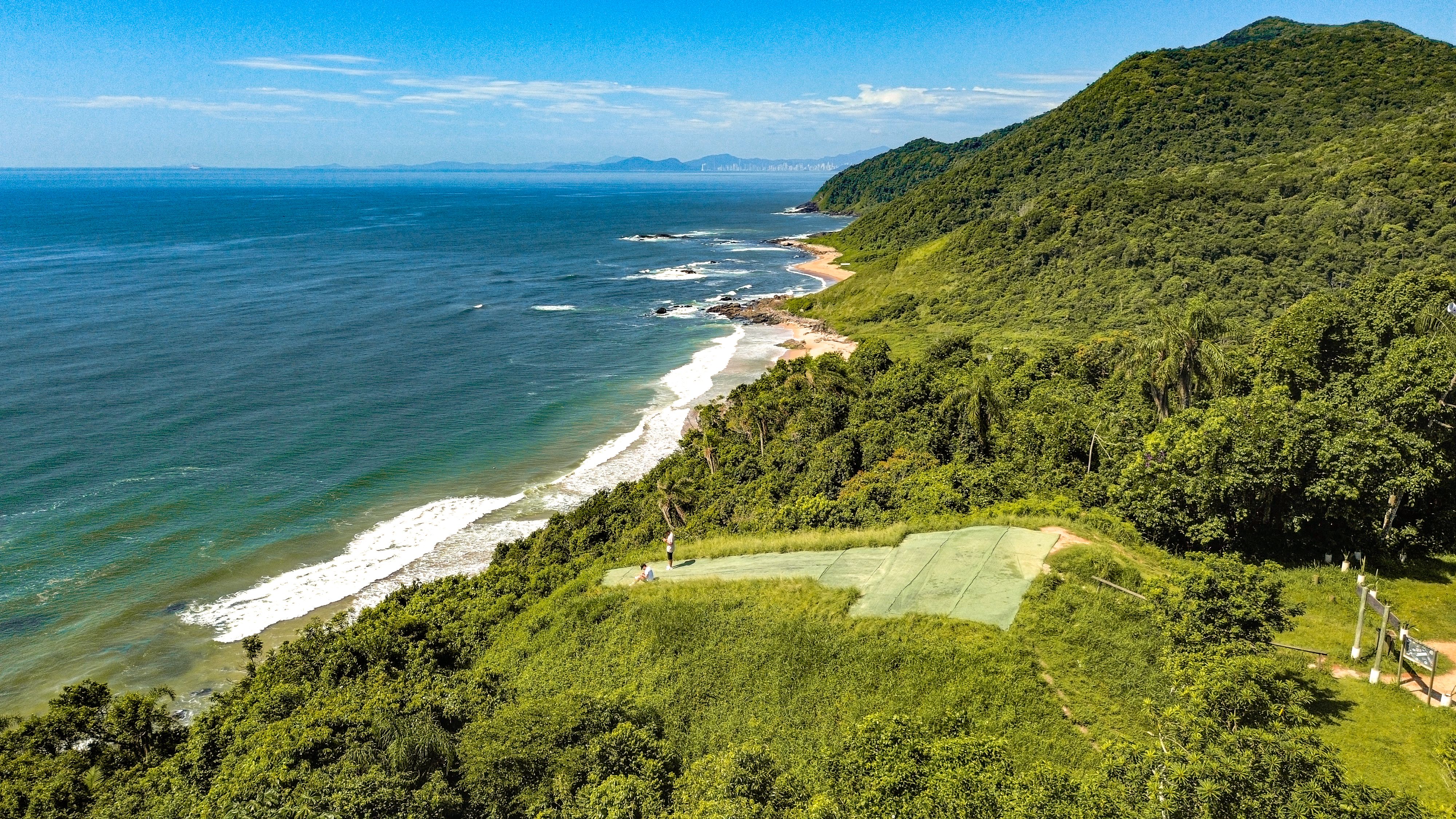 Aerial view of a curved white-sand beach in southern Santa Catarina.