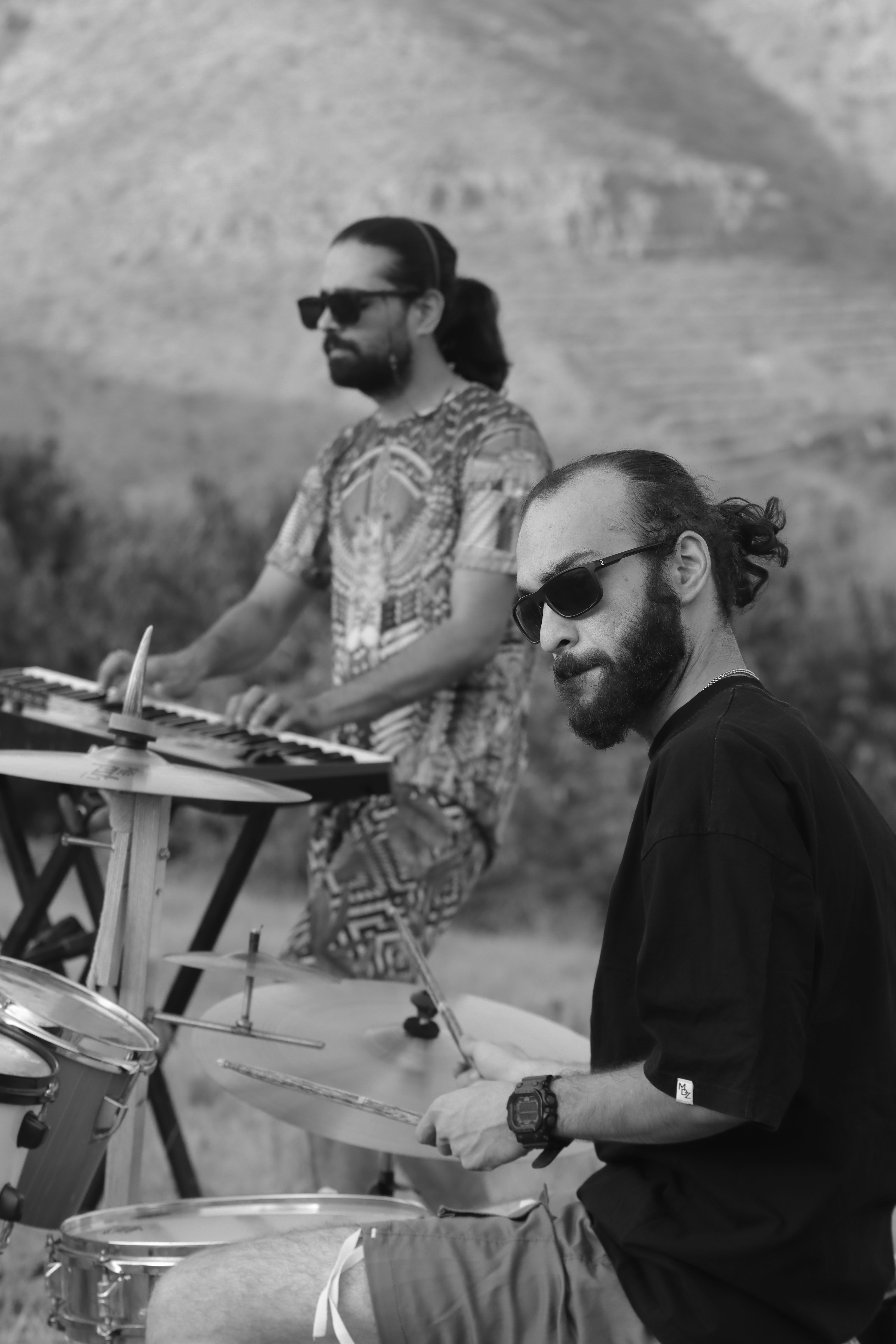 Musicians playing drums and keyboard in an outdoor setting in Qazvin, Iran.