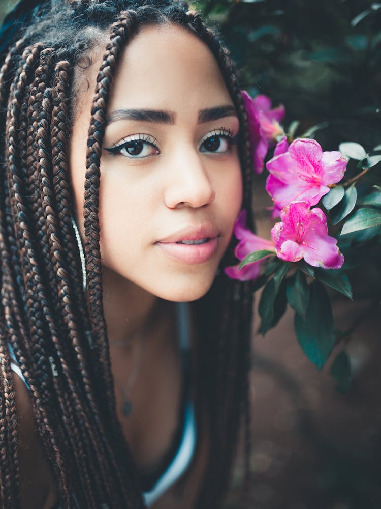 Woman Standing Beside Pink Flowers