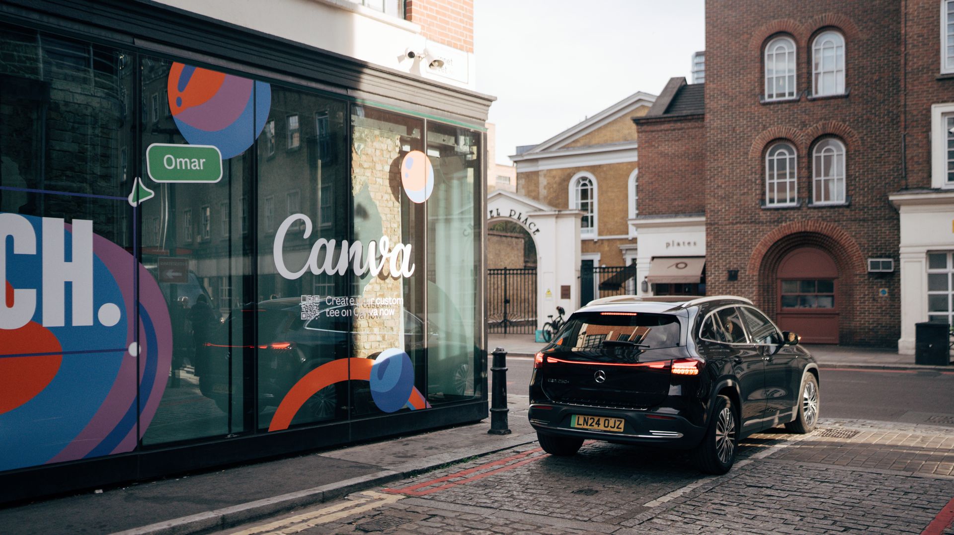 City street with modern car by a creative storefront display.