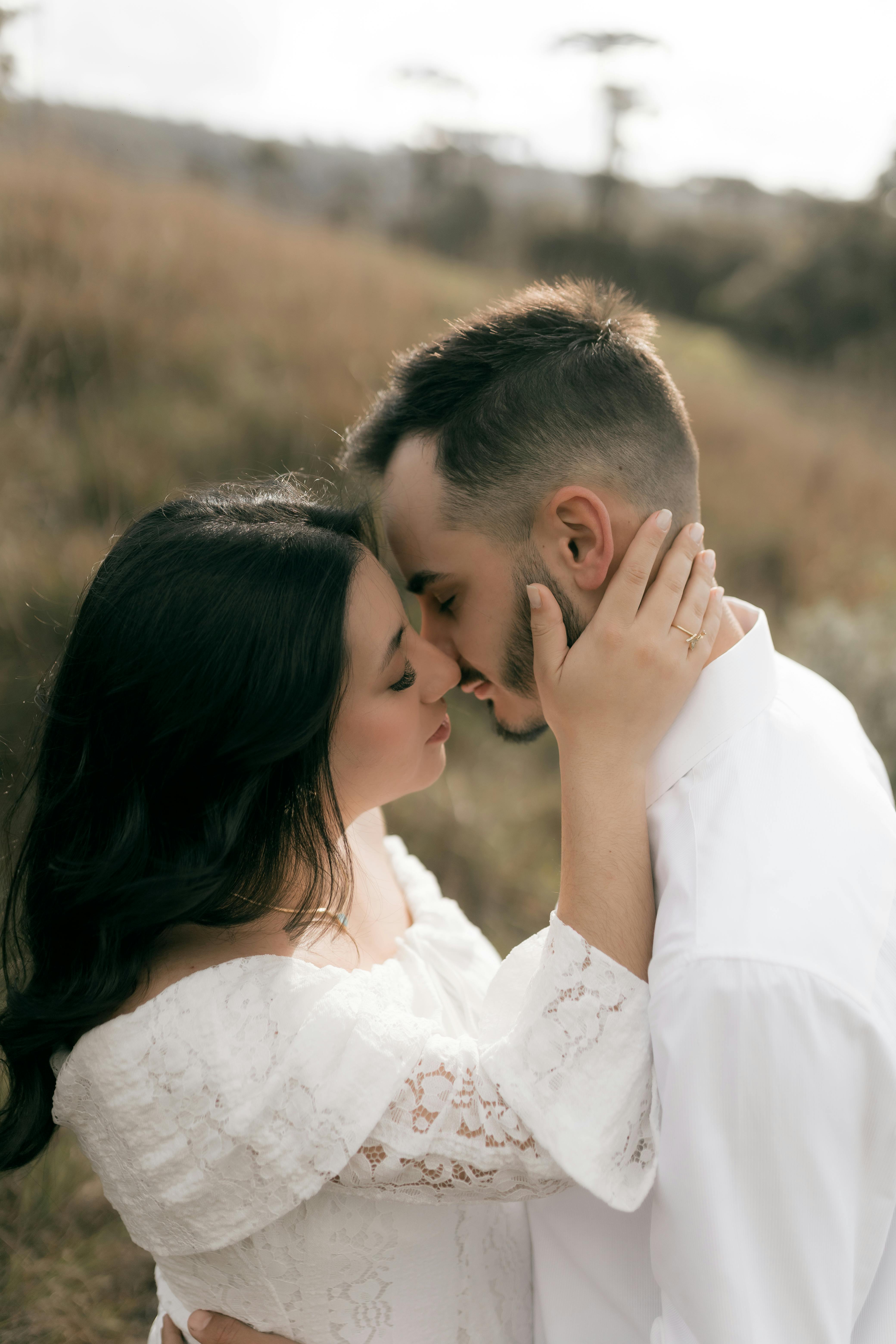 Romantic couple embracing in soft warm lighting, evoking tender autumn intimacy as rain falls outside
