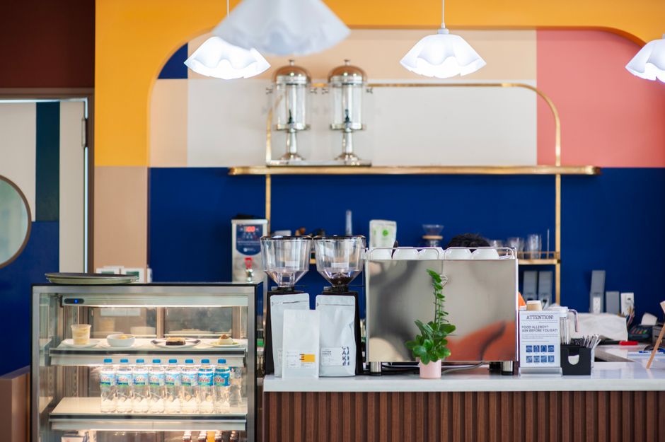 A vibrant Chicago cafe interior featuring lush indoor plants and neon wall art - cute coffee shops chicago A vibrant Chicago cafe interior featuring lush indoor plants and neon wall art - cute coffee shops chicago