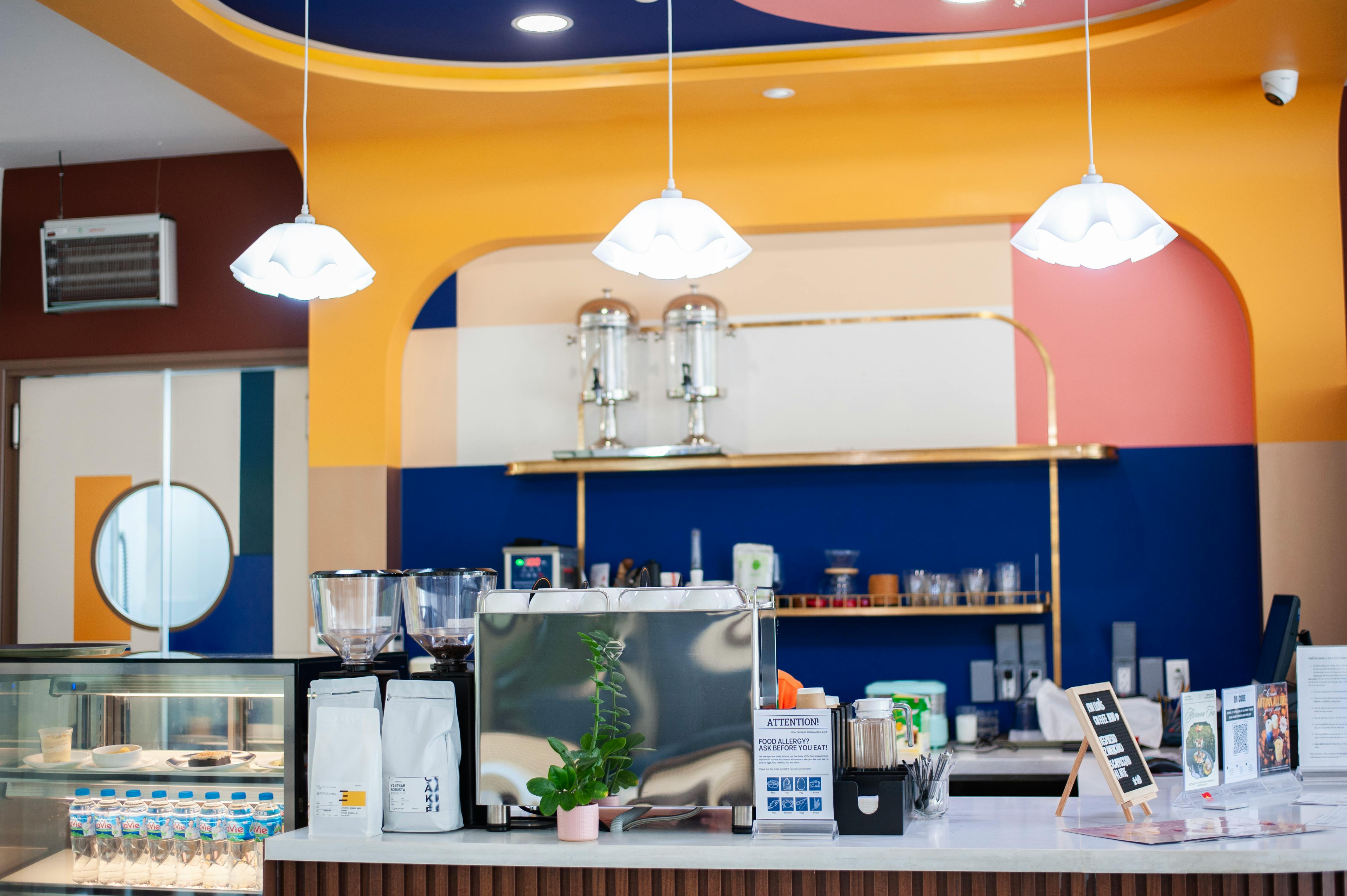  Contemporary cafe interior featuring vibrant Art Deco design, elegant lighting, and a minimalist style.