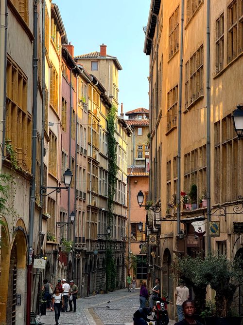 Free Explore a colorful historic street in Lyon, France, capturing urban charm and vibrant architecture. Stock Photo