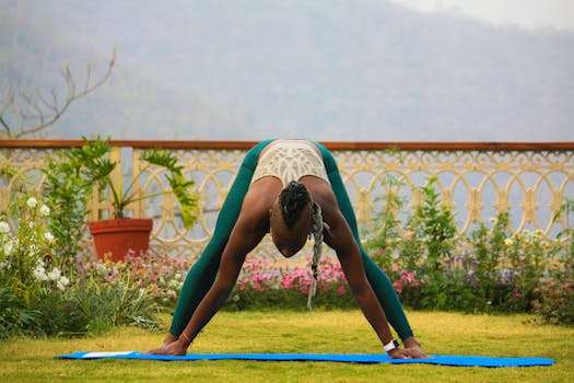 Woman practicing yoga outdoors in a lush garden in Rishikesh, India.