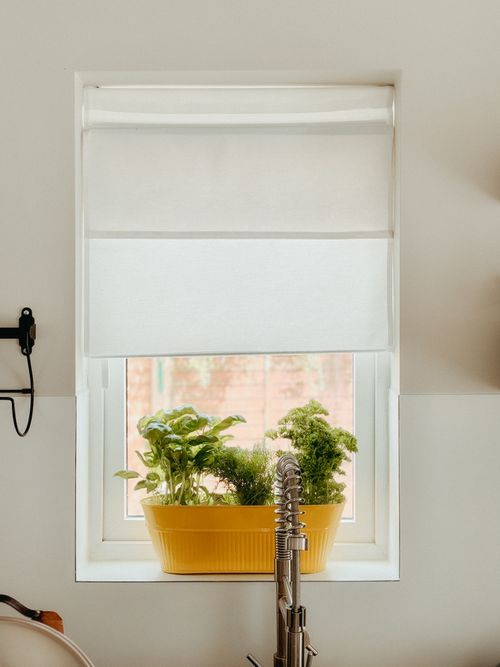 Free Bright kitchen window with fresh herbs in a yellow pot, perfect for home cooking enthusiasts. Stock Photo