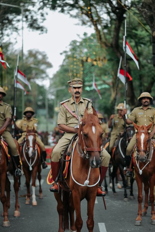 Free A group of mounted police officers participating in a ceremonial parade with flags and uniforms. Stock Photo