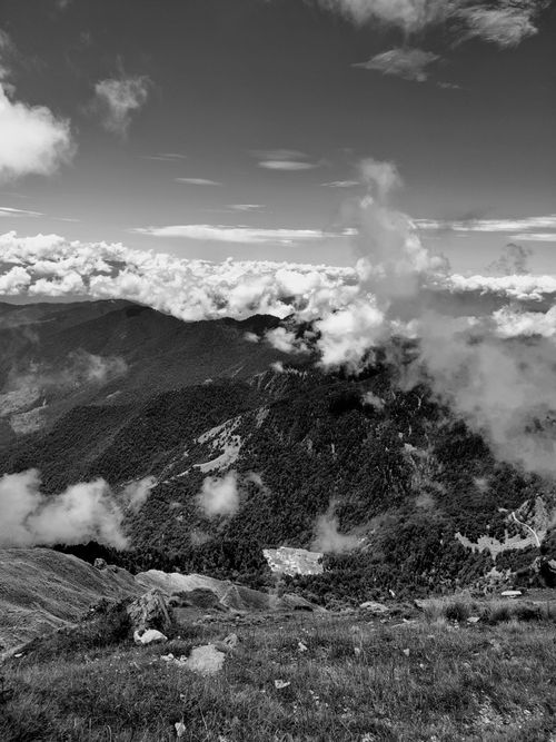 Free Breathtaking aerial view of rugged mountains with clouds in monochrome. Stock Photo