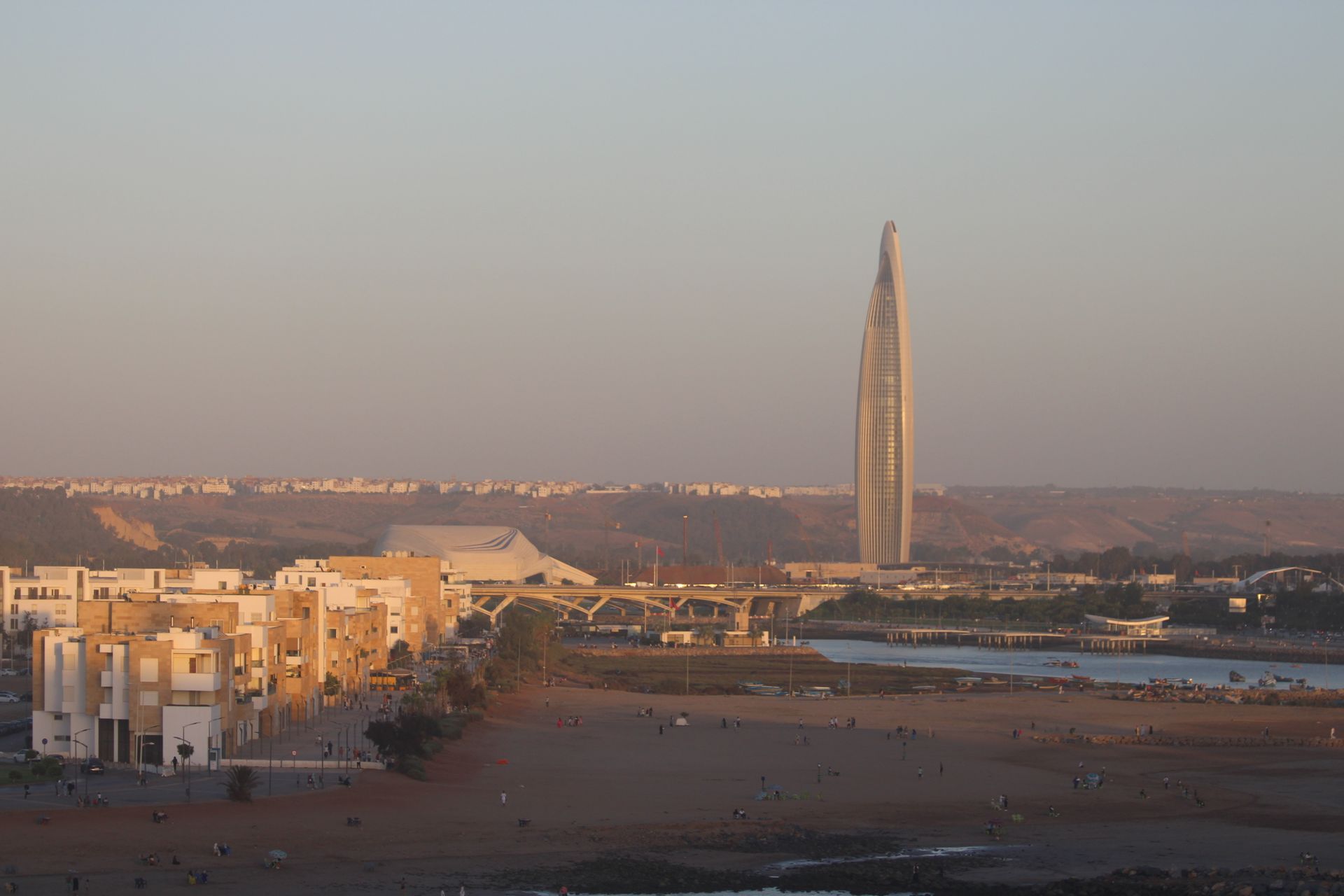 A scenic sunset view in Rabat, Morocco showcasing a modern tower and urban landscape.