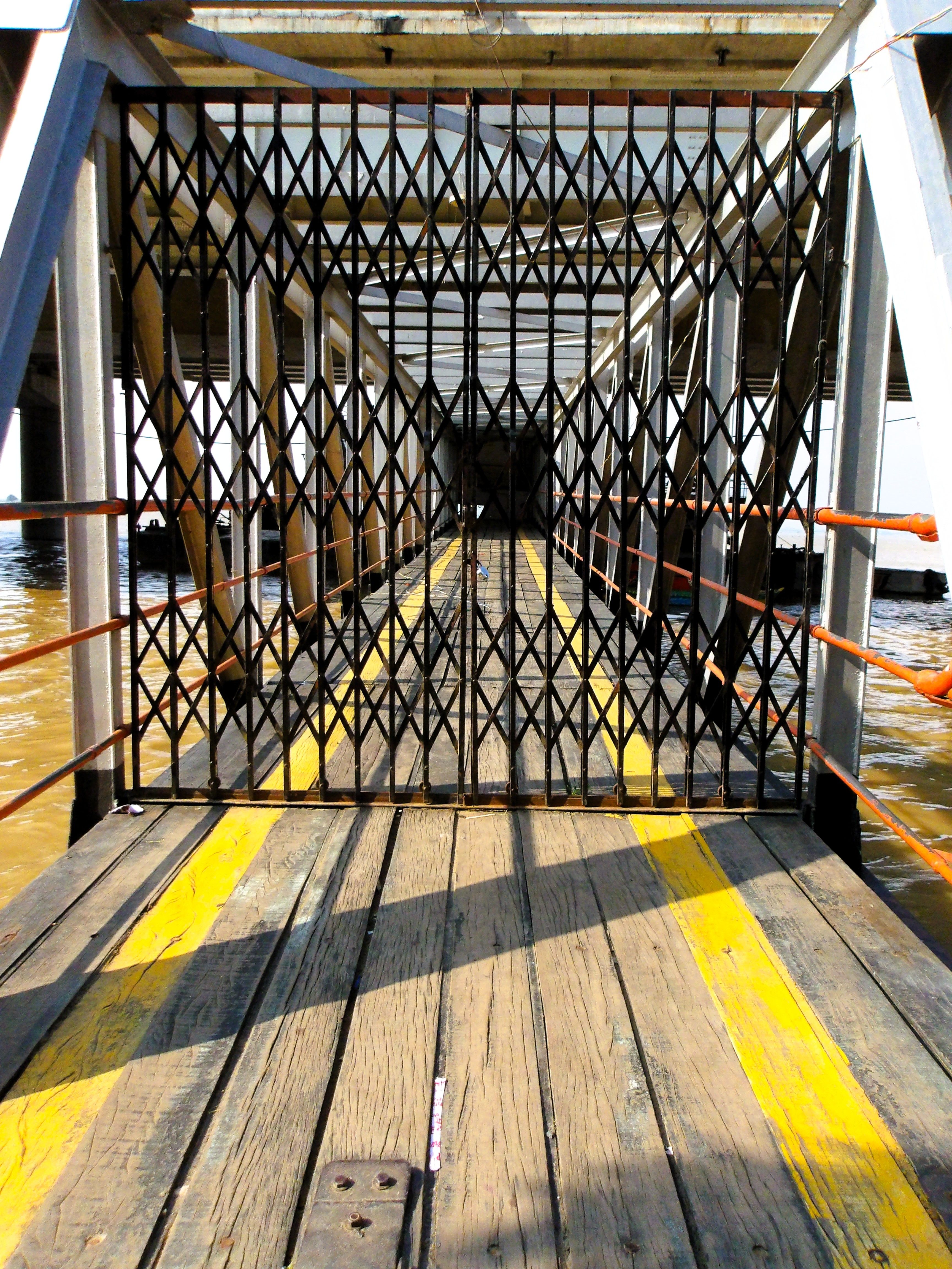 Symmetrical view of dockside gate with geometric design · Free Stock Photo