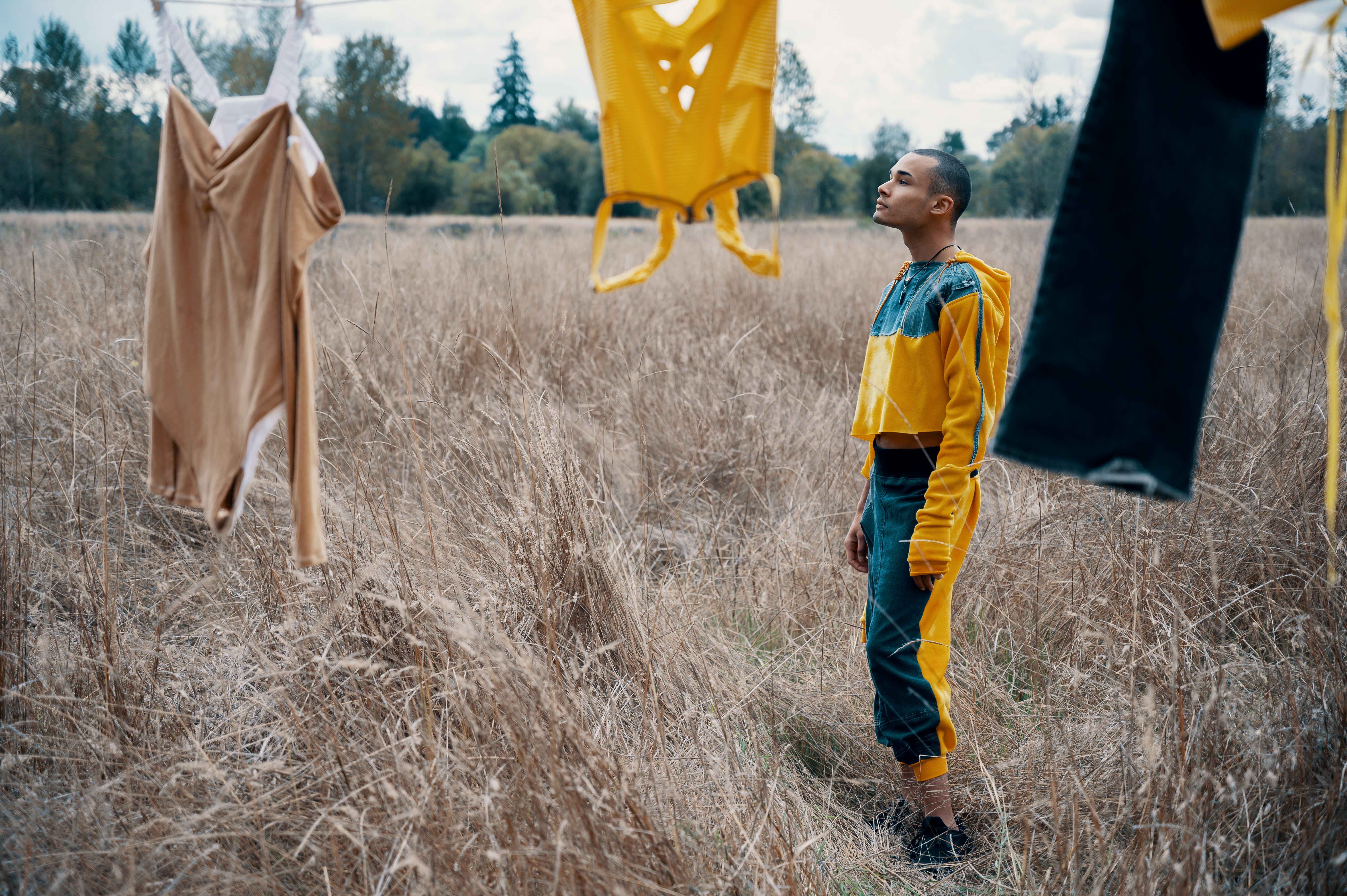 Man Standing Beside Hanged Clothes Free Stock Photo