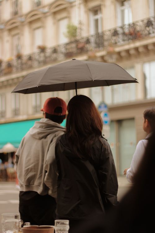 Couple With Umbrella Strolling in Rainy Paris · Free Stock Photo