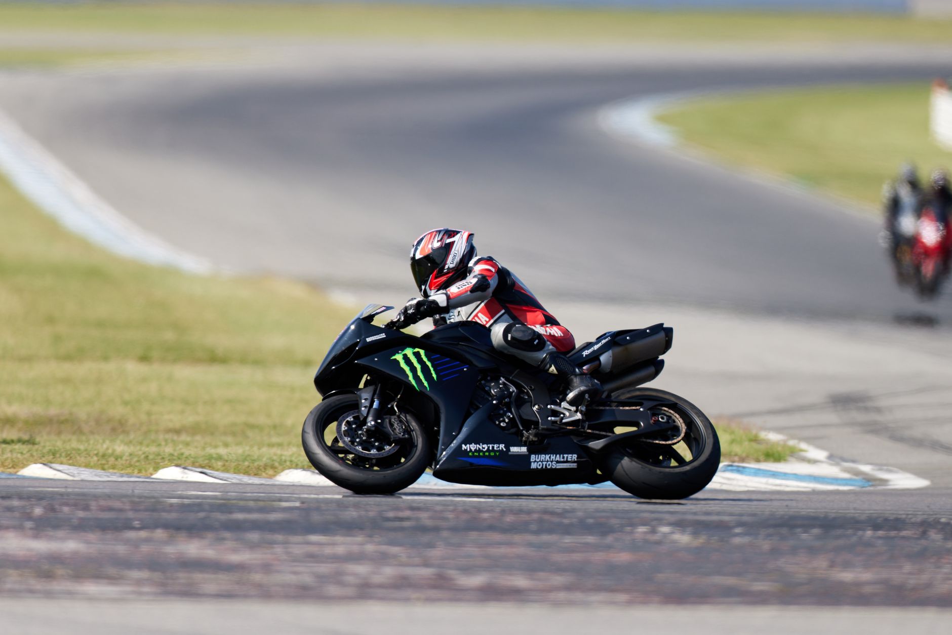 Motorcycle racer taking a sharp turn on Hockenheimring circuit in Germany.