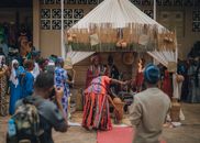 A vibrant traditional African ceremony with people in colorful ethnic attire taking part in a cultural ritual.