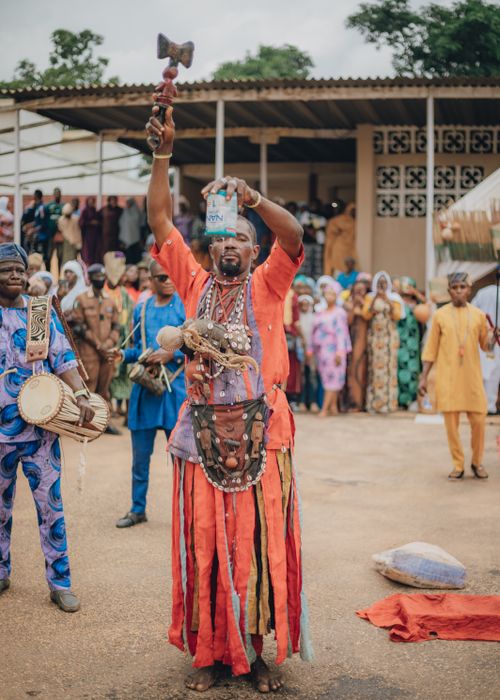 Free Vibrant African cultural ceremony featuring a performer in traditional attire, showcasing local heritage. Stock Photo