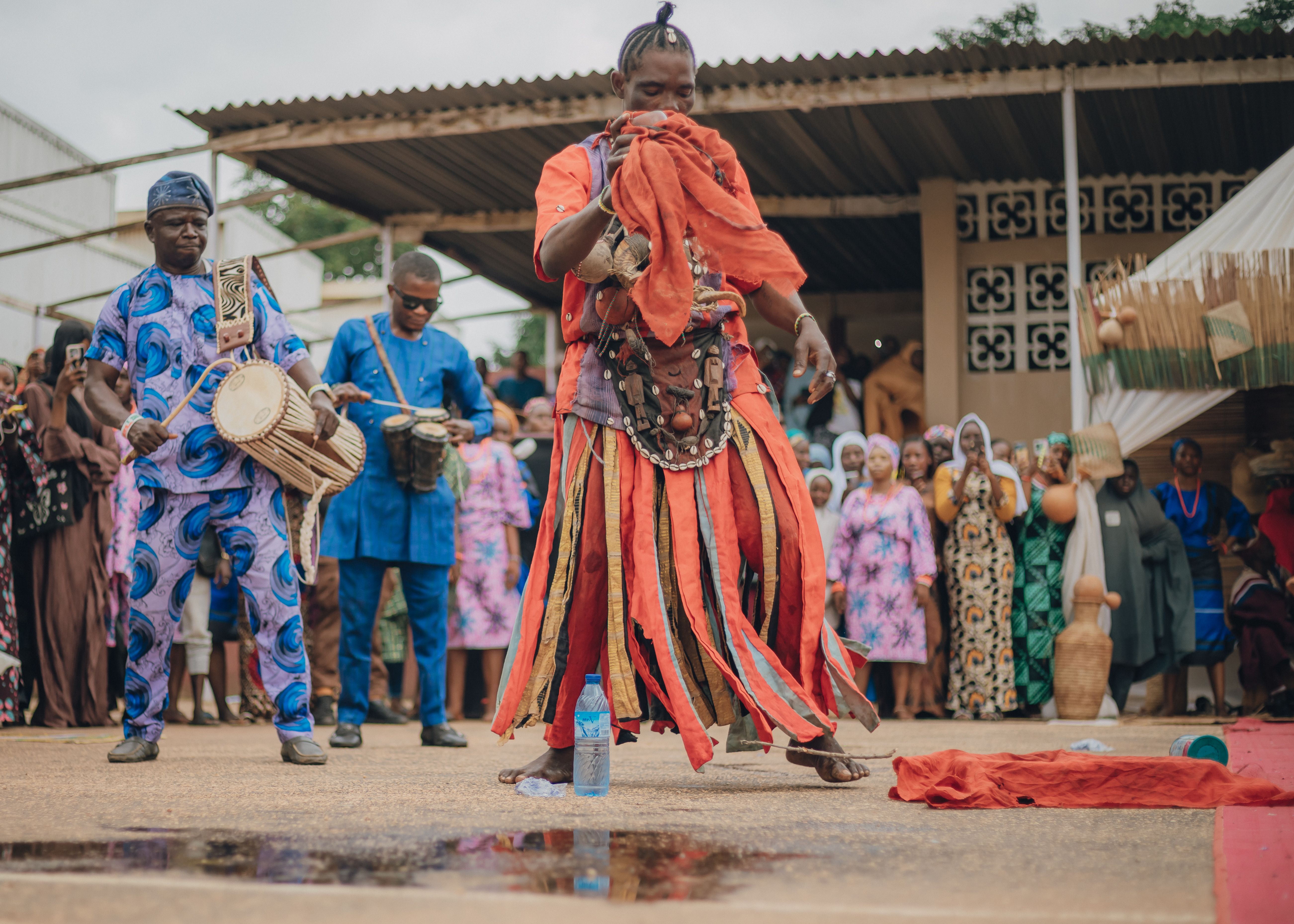 A vibrant traditional dance performance in Africa with colorful costumes and drumming.