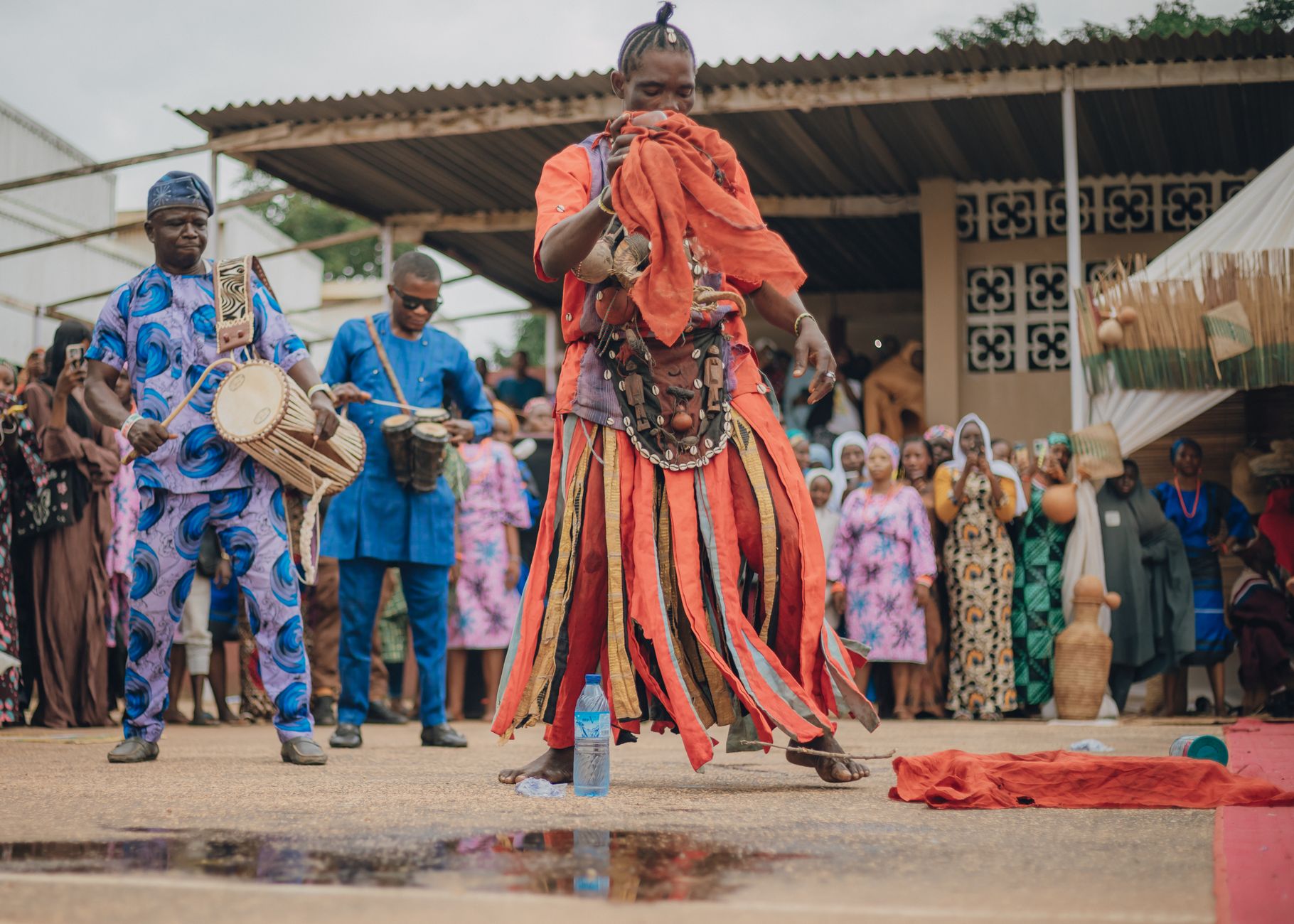 A vibrant traditional dance performance in Africa with colorful costumes and drumming.