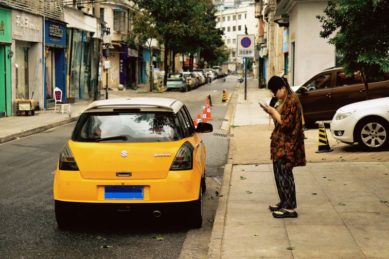 Person checking a phone in a parked car