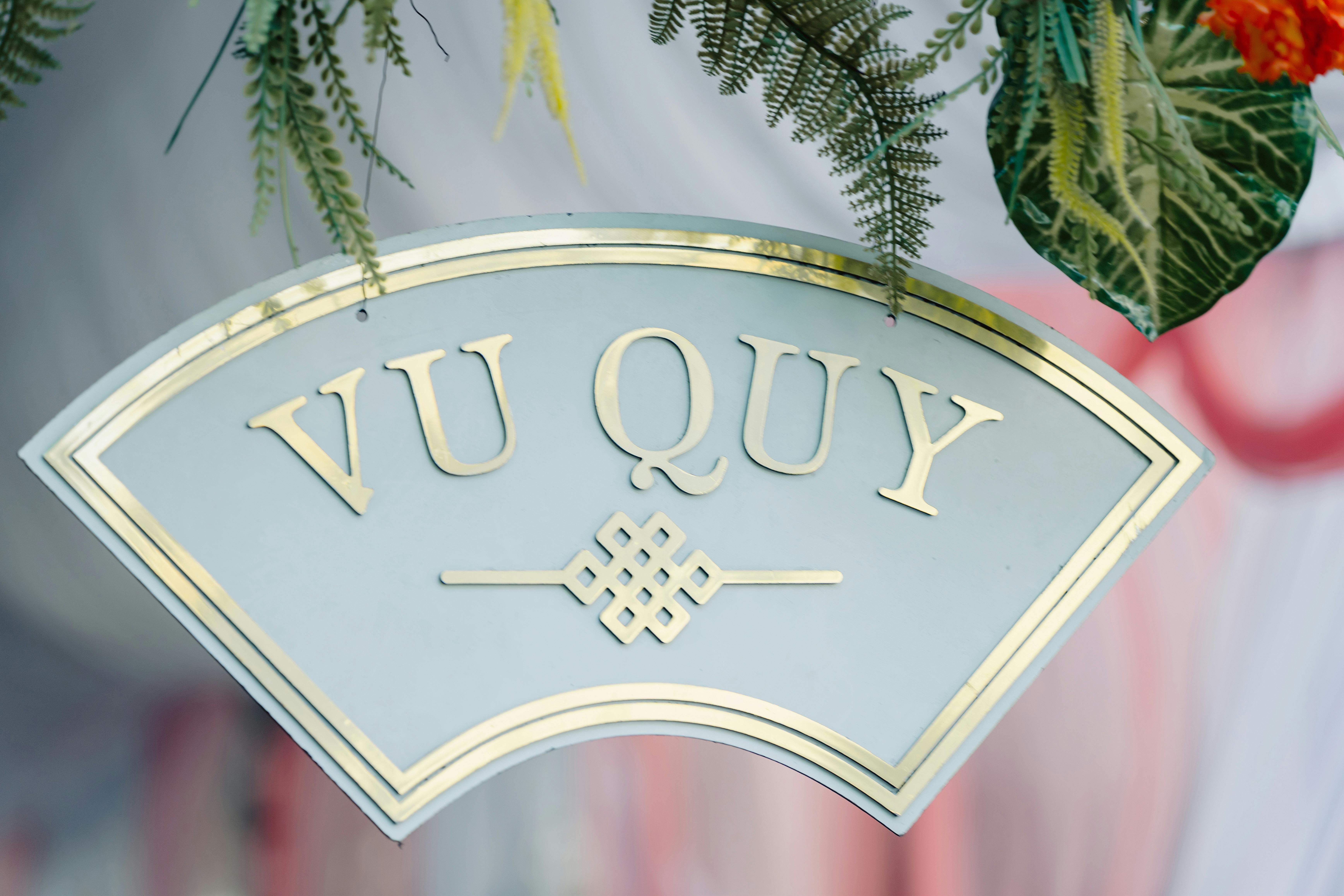 Close-up of a Vu Quy wedding sign adorned with greenery, symbolizing a traditional Vietnamese marriage ceremony.