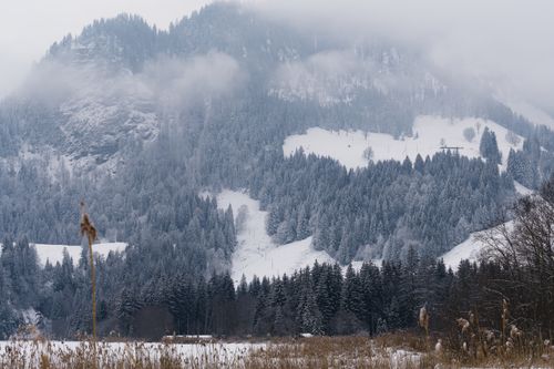 Free A breathtaking view of snow-covered mountains in a serene Swiss winter scene. Stock Photo