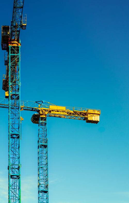 Free Bright construction cranes against a blue sky in Budapest, Hungary. Stock Photo