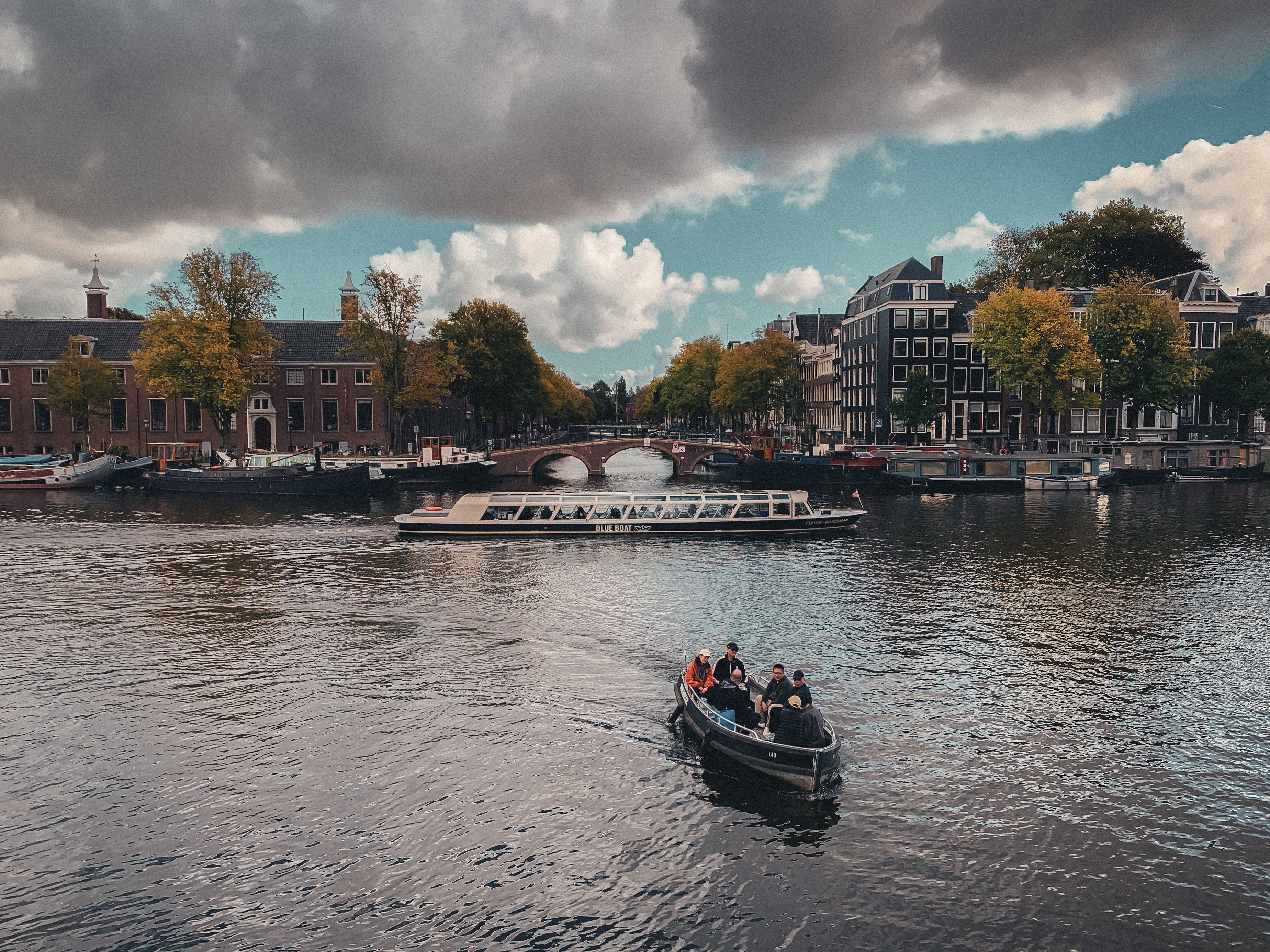 Picturesque canal view with boats and historic buildings in Amsterdam, Netherlands.