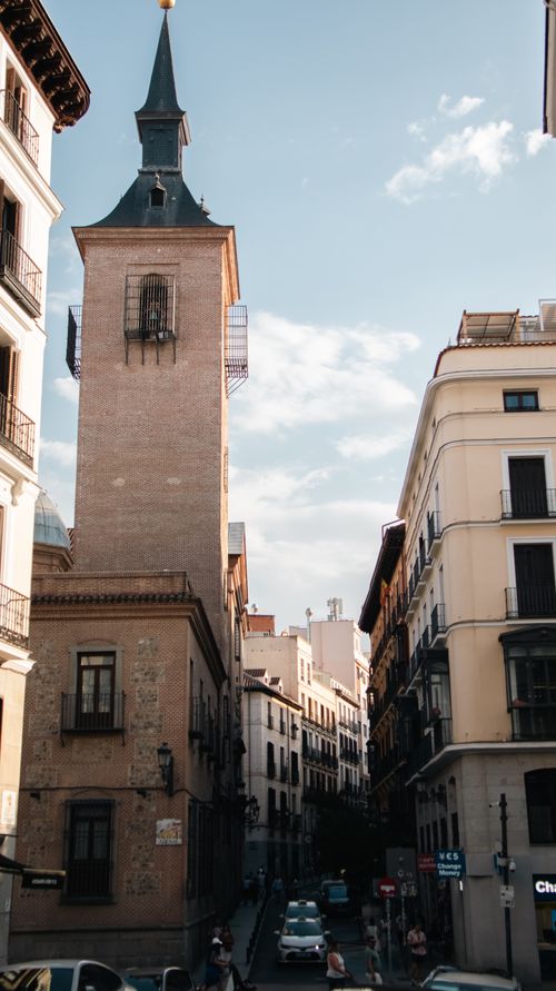 Free A charming view of a historic street in Madrid, Spain, with traditional architecture and a bustling atmosphere. Stock Photo