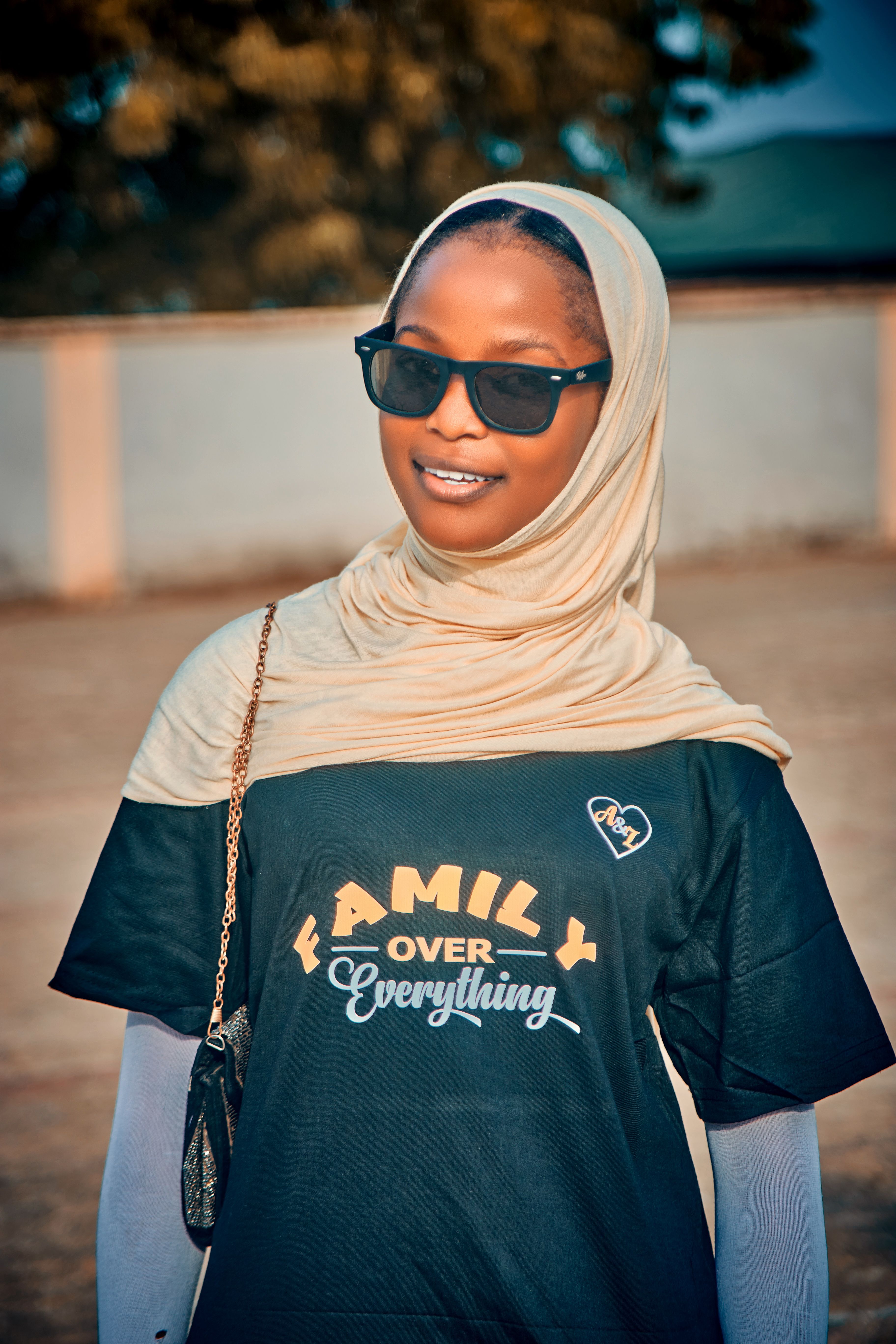 Portrait of a young woman wearing sunglasses and hijab in Birnin Gwari, Nigeria.