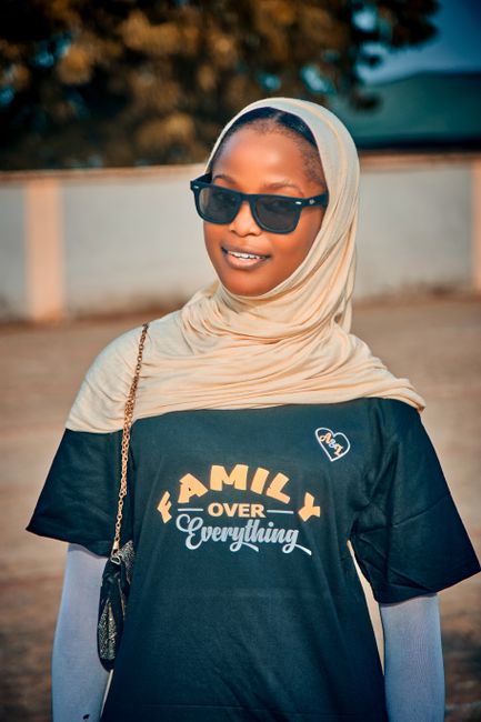Portrait of a young woman wearing sunglasses and hijab in Birnin Gwari, Nigeria.
