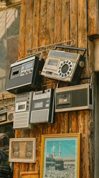 A collection of retro radios adorning a rustic wooden wall, showcasing vintage charm.