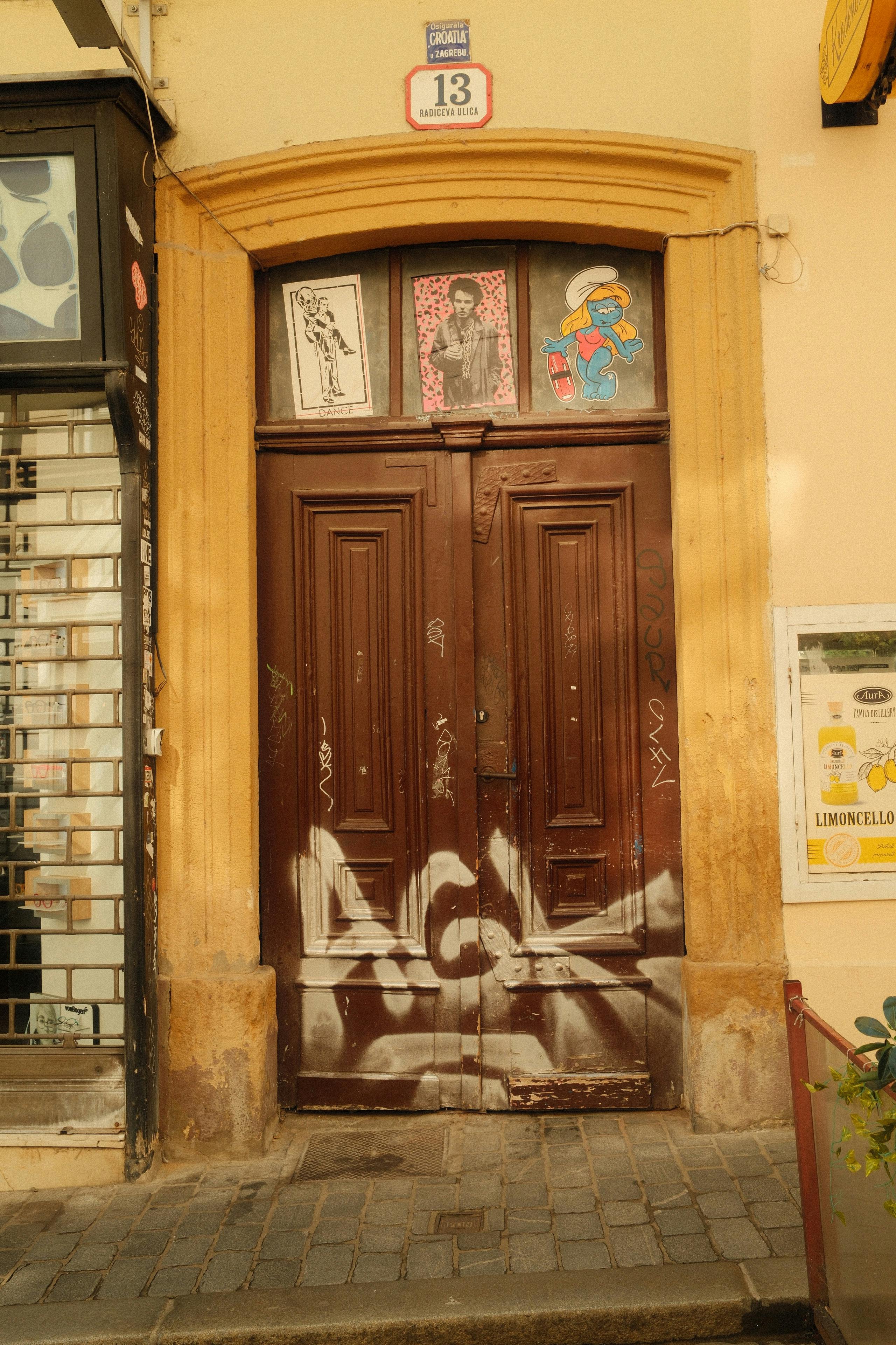 Discover a rustic, graffiti-covered doorway in the vibrant streets of Zagreb, Croatia.