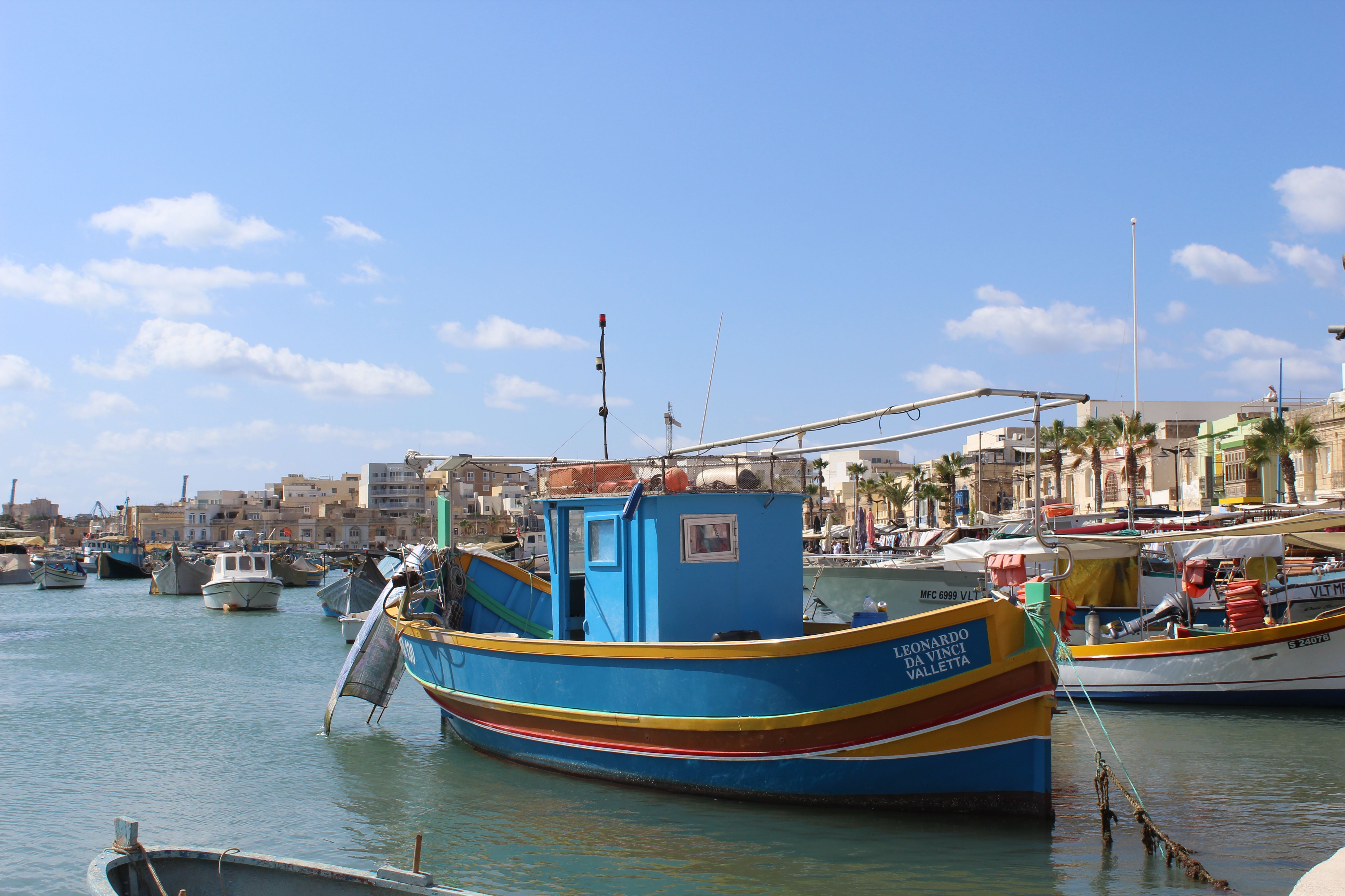 Traditional colorful fishing boats in Marsaxlokk harbor, Malta