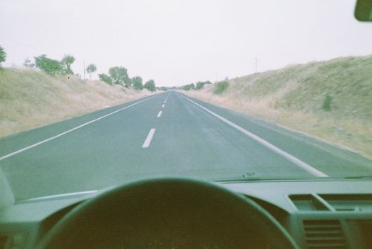 Experience a serene drive on an open road stretching into the horizon in Türkiye.