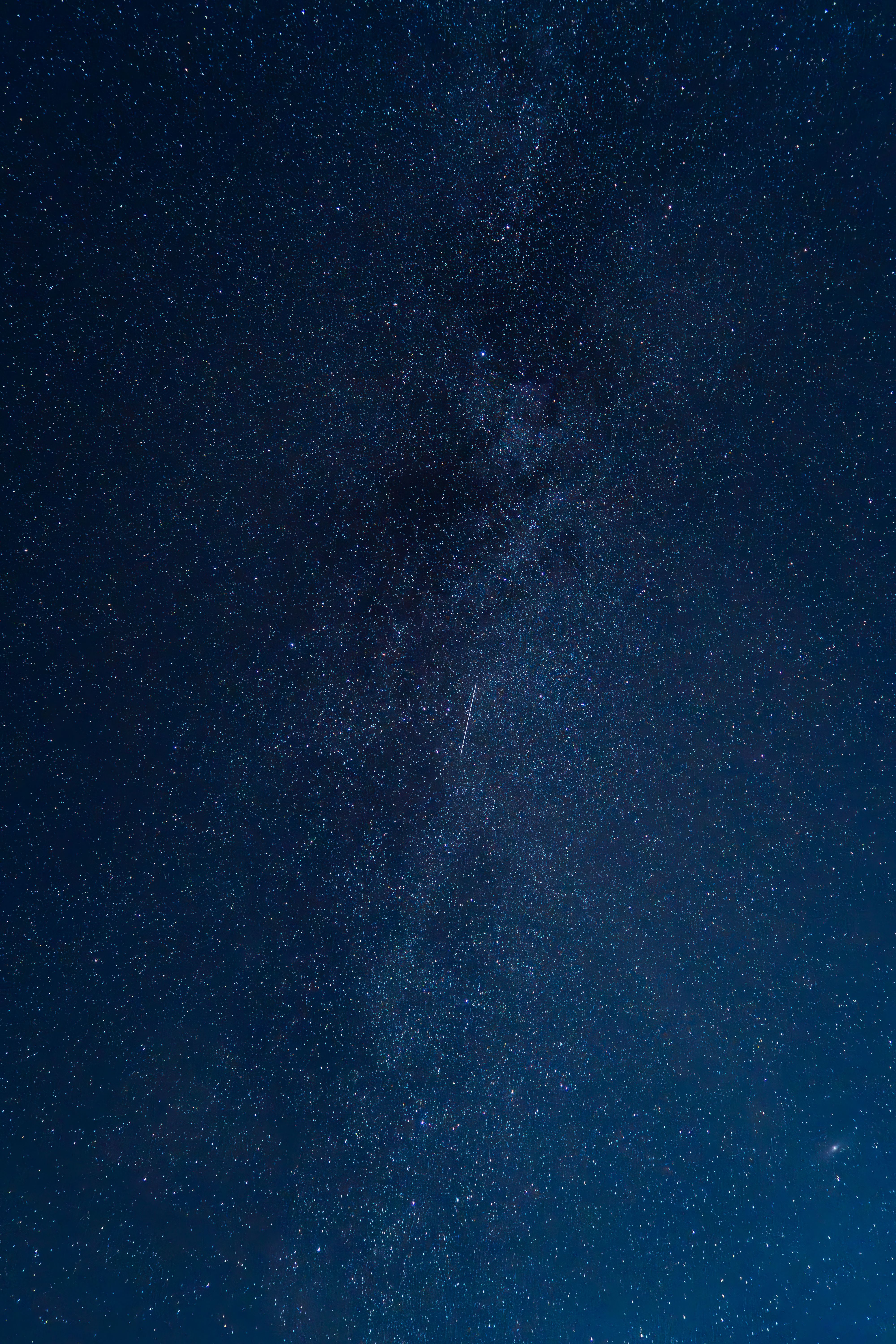 Stunning view of the Milky Way with a shooting star in a clear night sky.
