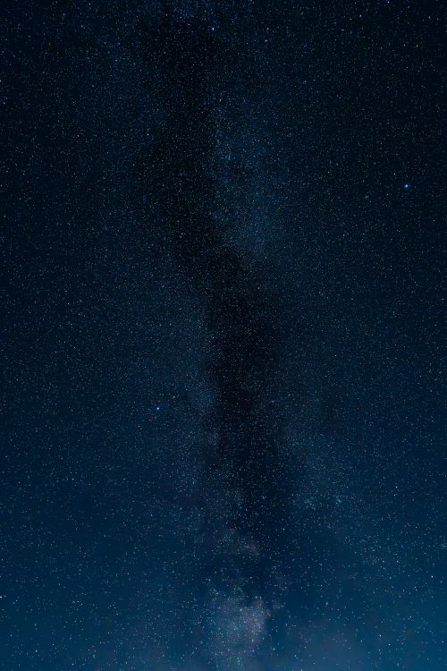 Free Breathtaking long exposure of a starry night sky showcasing the Milky Way's cosmic beauty. Stock Photo