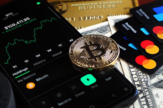 Bitcoin coin with financial data, credit cards, and currency on a desk.