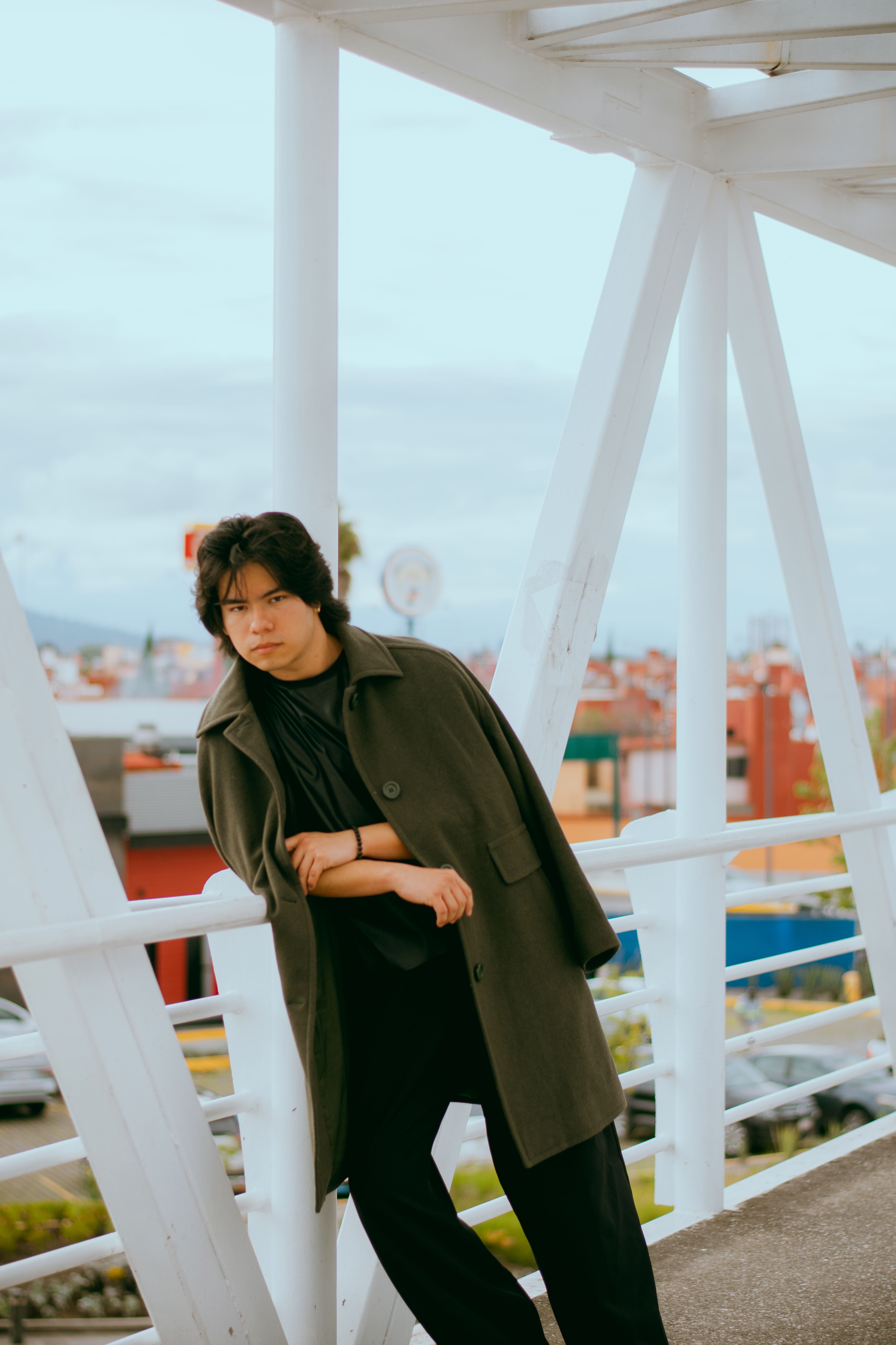 Stylish Young Adult on Modern Pedestrian Bridge · Free Stock Photo
