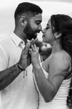 A loving couple shares an intimate moment in this elegant black and white portrait.