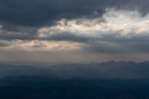 A moody cloudscape view over mountainous terrain in Minas Gerais, Brazil during twilight.