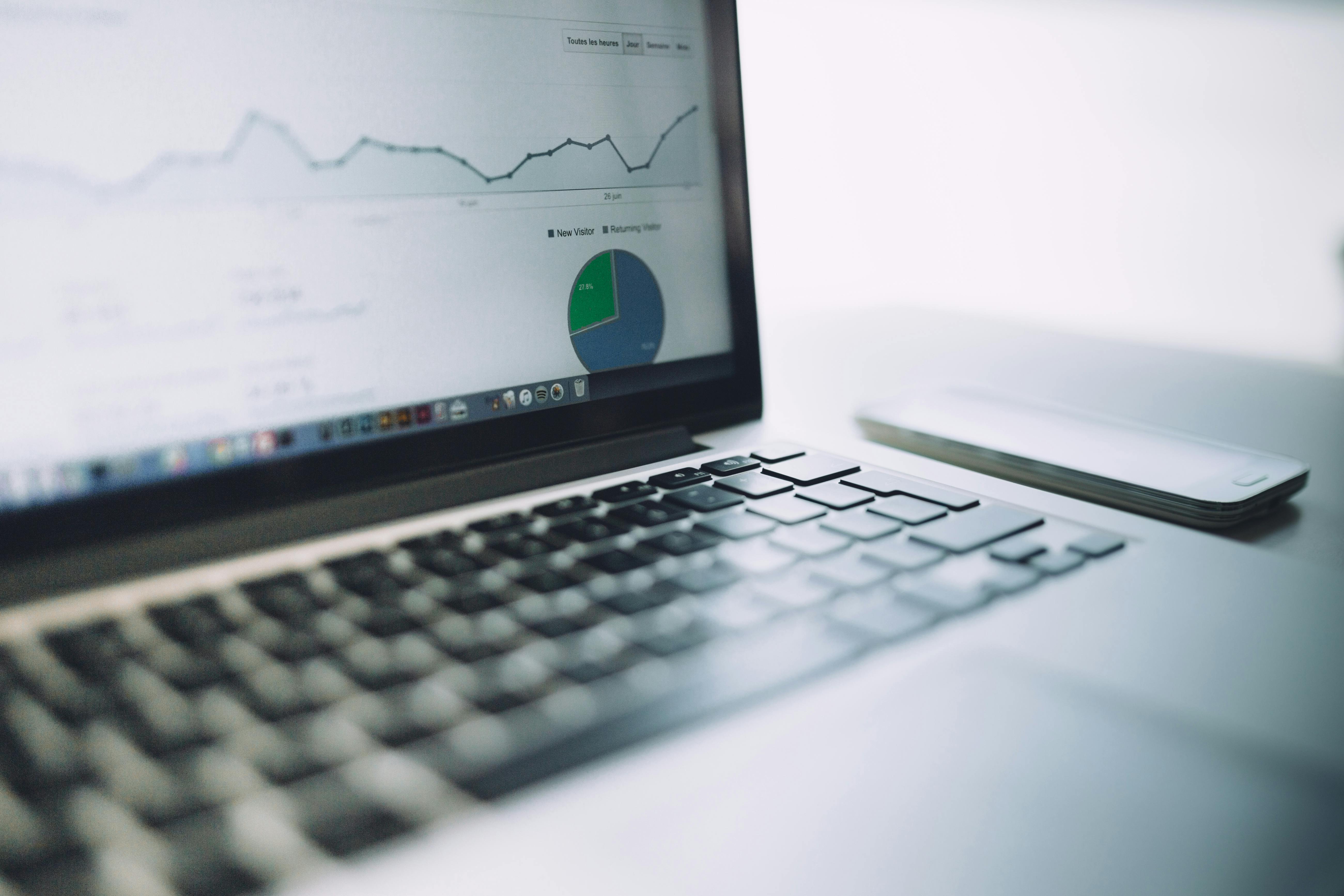 A laptop showing an analytics dashboard with charts and graphs, symbolizing modern data analysis tools.