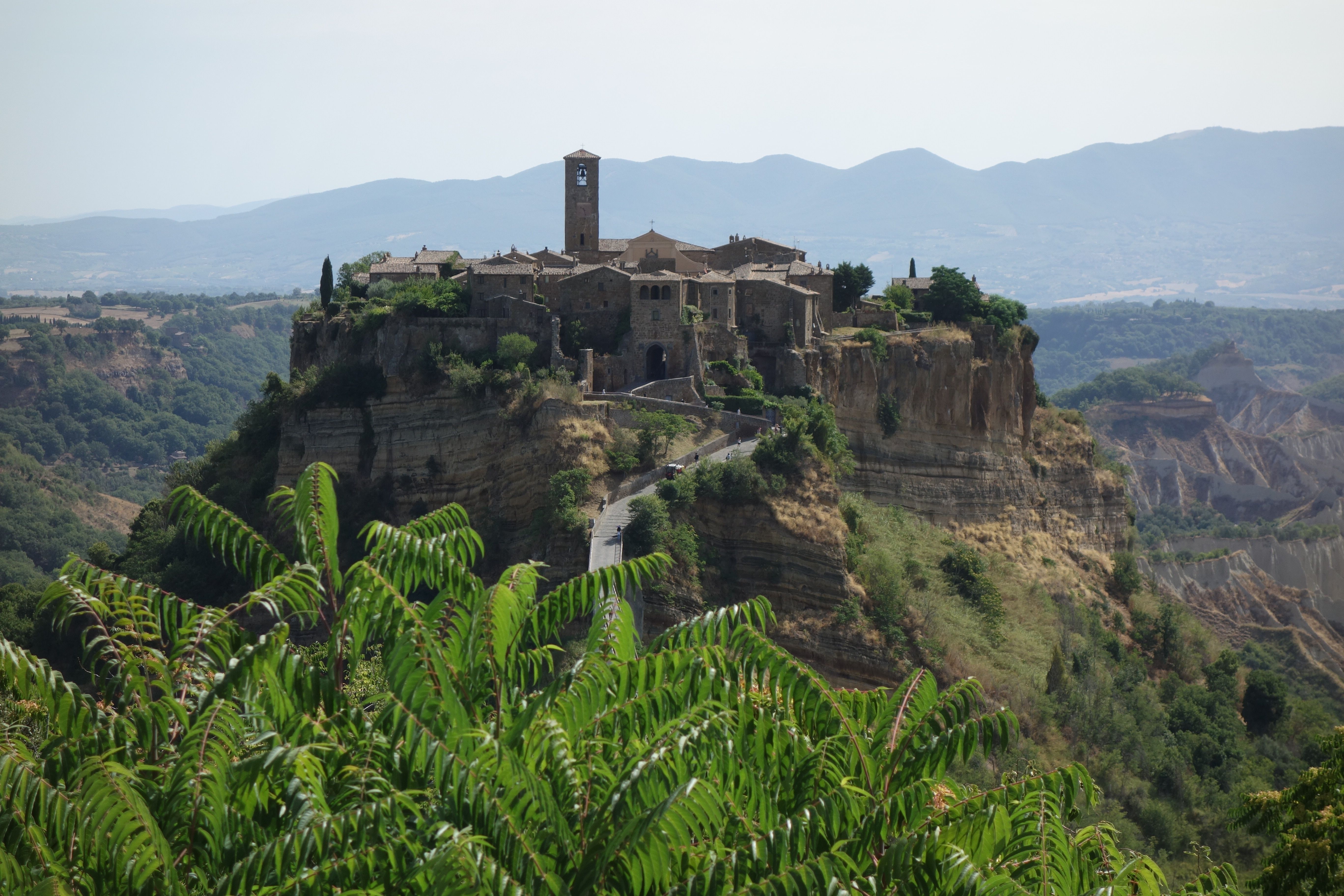 A breathtaking view of Civita di Bagnoregio, Italy, captured from a lush green viewpoint.