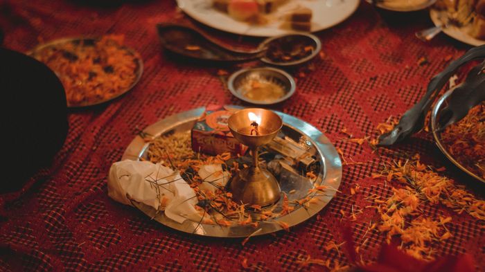 Oil lamp and flower petals arranged for worship