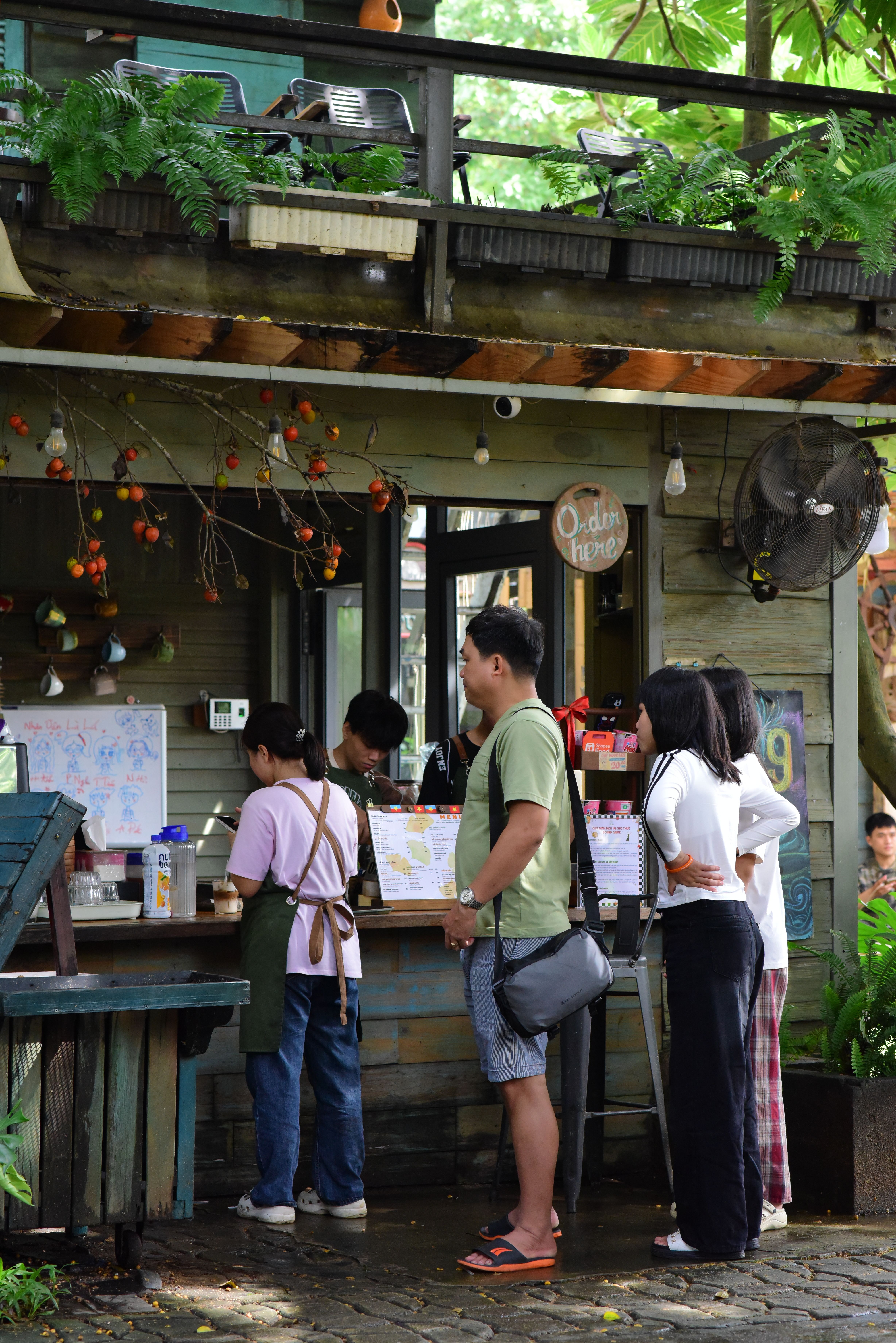 People Ordering at a Rustic Outdoor Café · Free Stock Photo