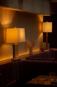 Warm ambient lighting in a cozy restaurant setting, with modern decor and soft mood lighting.