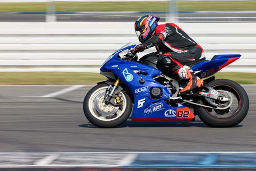 Free Dynamic shot of a motorcycle racer speeding on Hockenheim circuit in Germany. Stock Photo
