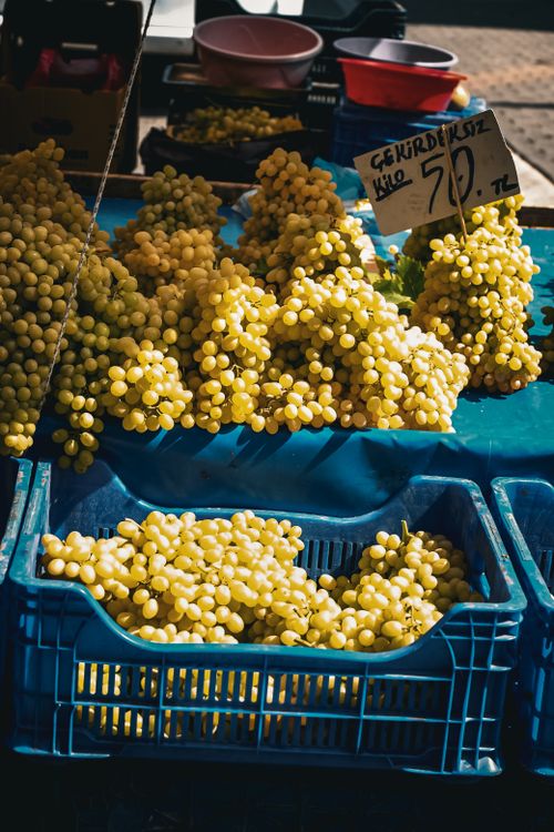 Free Vibrant yellow grapes displayed at a market stand, priced 50 TL per kilo. Stock Photo