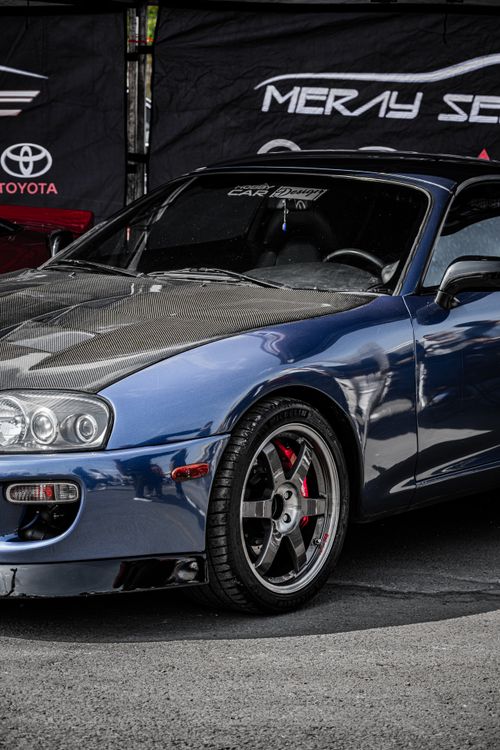 Free A striking blue sports car with a carbon fiber hood, showcased outdoors in Ankara, Türkiye. Stock Photo