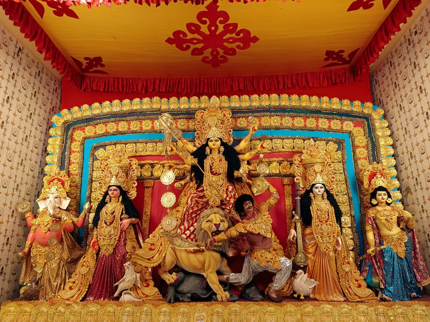 Colorful Durga Puja idol display with intricate decorations in Kolkata, India.