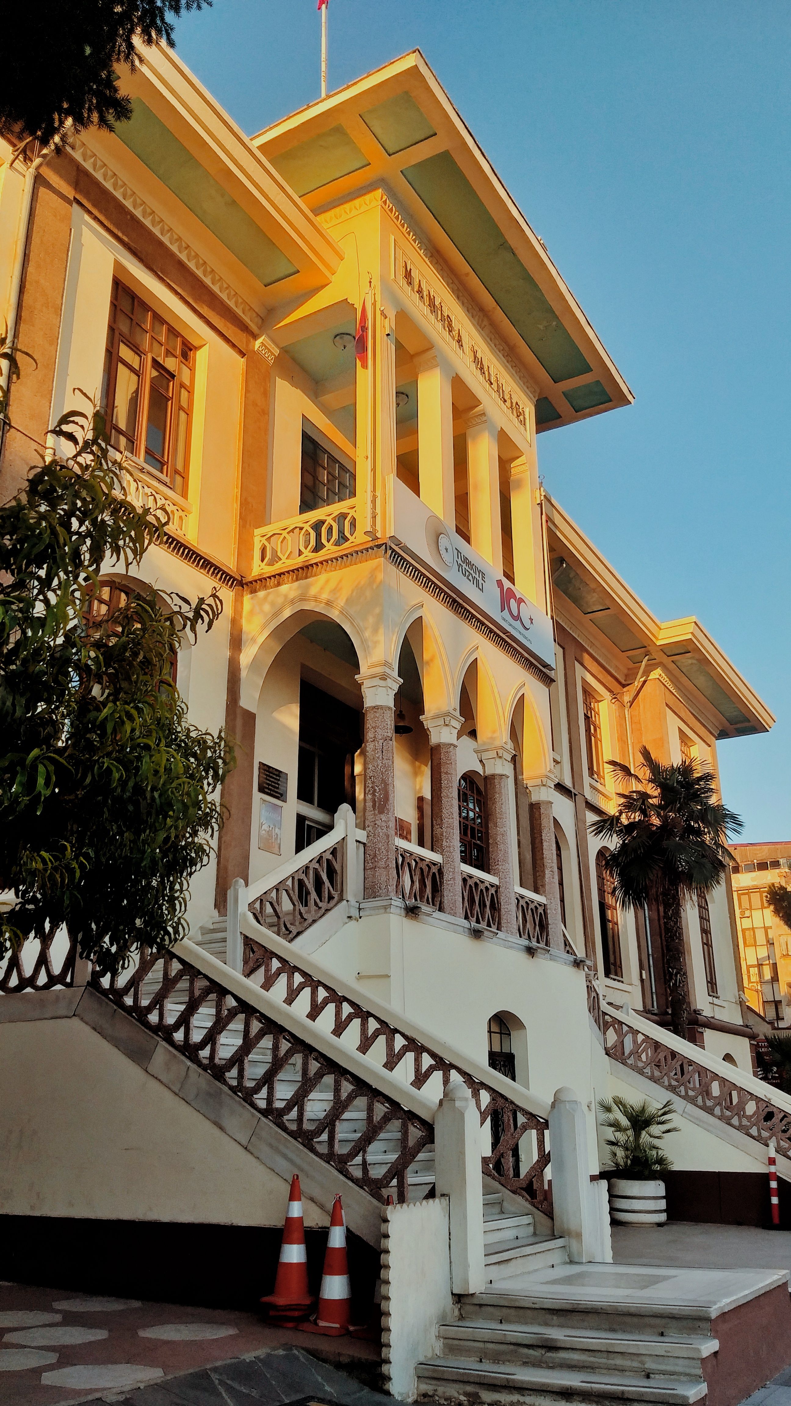Elegant historic building in Manisa, Türkiye, showcasing classic architecture at sunset.