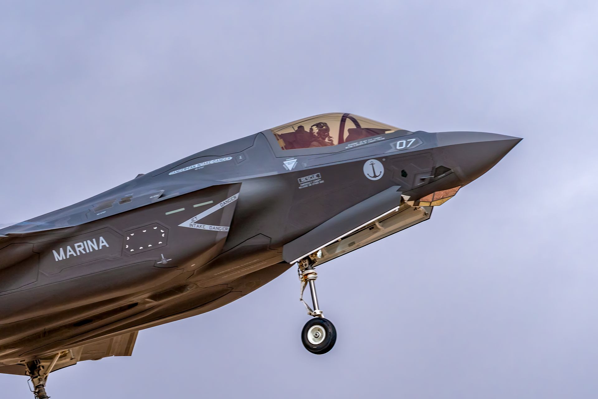 F-35 fighter jet soaring through the sky, showcasing modern military aviation technology.
